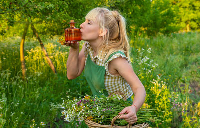 Side view of young woman picking out