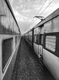 Train at railroad station platform against sky