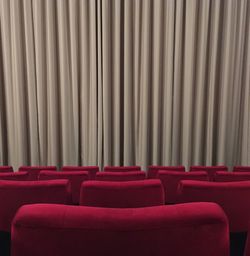 Empty red chairs in auditorium