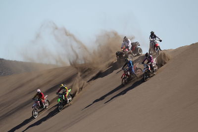 People motocross riding in desert
