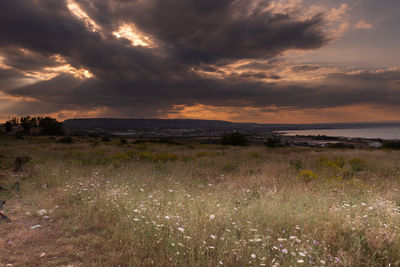 Scenic view of land against sky during sunset