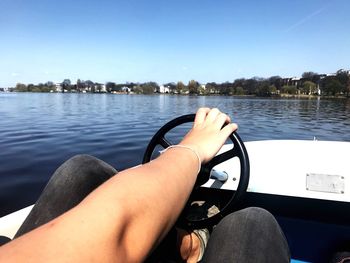 Low section of man on boat in lake
