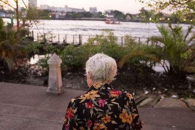 Rear view of senior adult standing at promenade