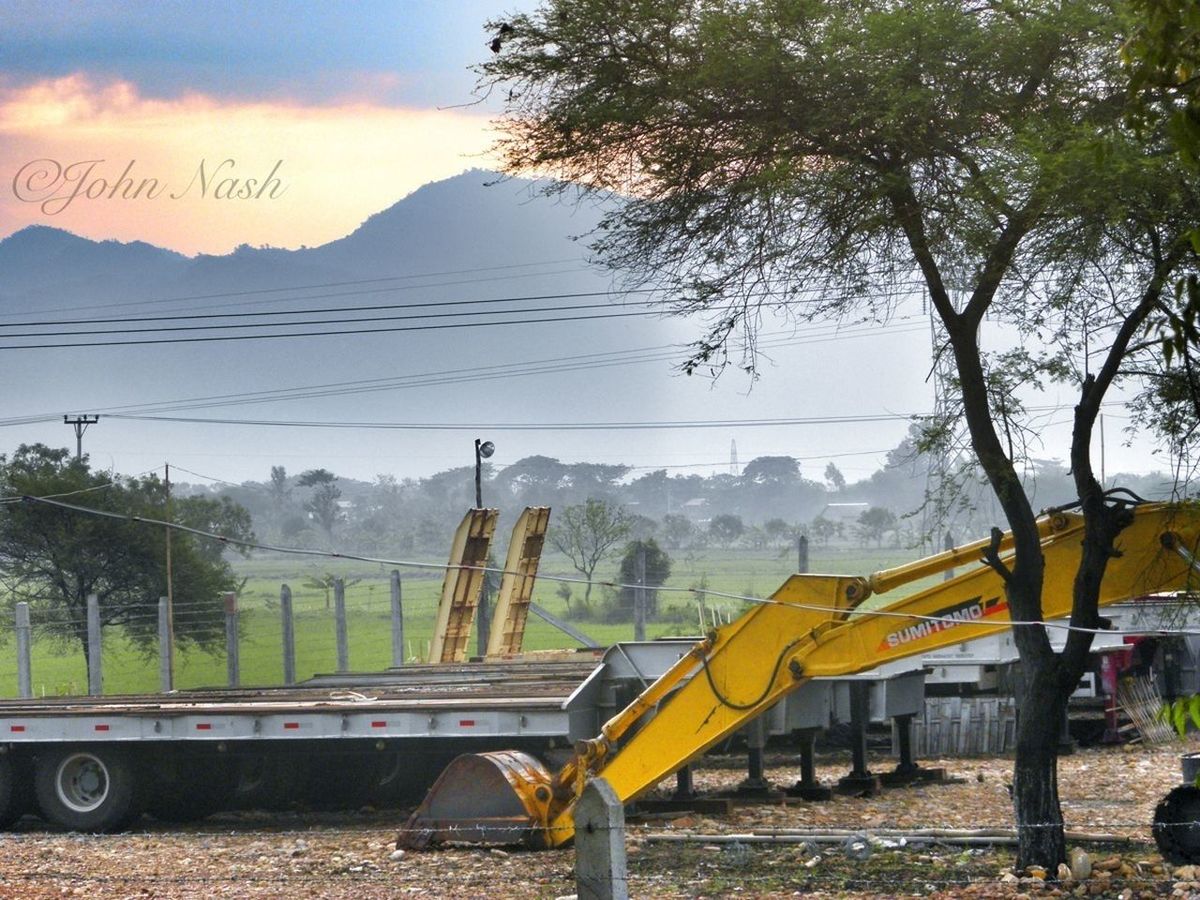 tree, transportation, sky, mountain, landscape, tranquility, nature, tranquil scene, beauty in nature, scenics, travel, outdoors, mode of transport, day, yellow, no people, road, non-urban scene, growth, sunlight