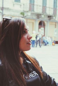 Portrait of smiling young woman in city
