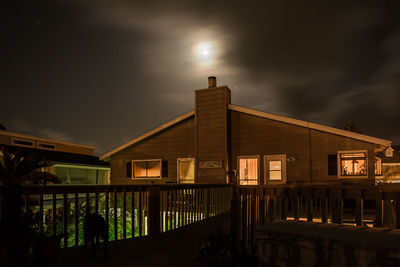 Illuminated building against sky at night