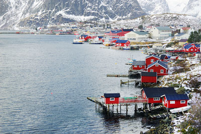 High angle view of townscape by sea against mountain