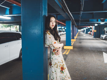 Portrait of woman standing at bus