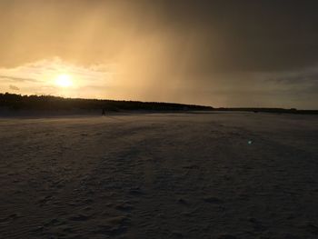 Scenic view of beach at sunset