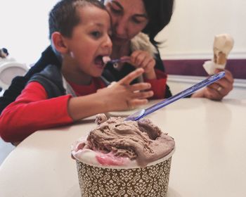 High angle view of girl holding ice cream on table