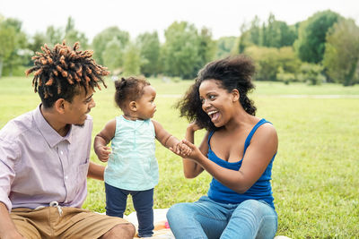 Family sitting on field