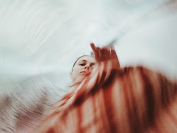 Close-up of hand on bed