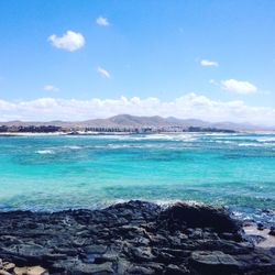 Scenic view of sea against cloudy sky