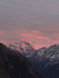 Scenic view of snowcapped mountains against sky during sunset