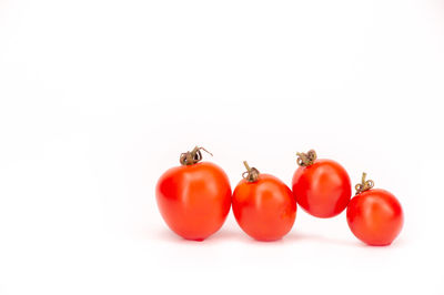 Close-up of tomatoes against white background