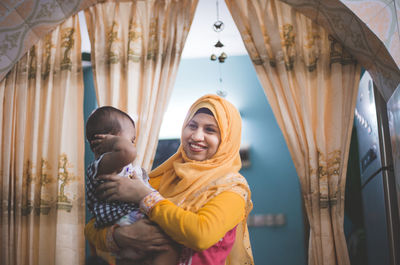 Happy friends standing against the wall