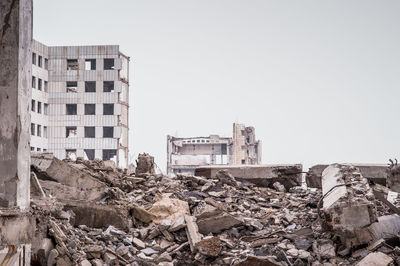 Abandoned building against sky in city