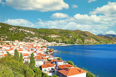 High angle view of townscape by sea against sky