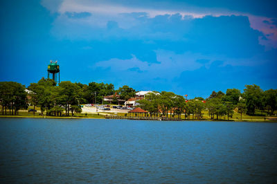 Scenic view of lake by building against sky