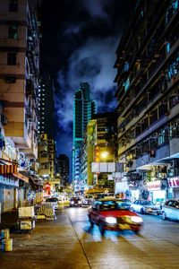 Illuminated city street and buildings at night