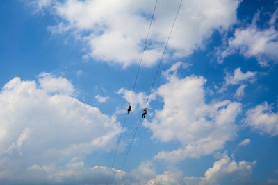 Low angle view of people ziplining