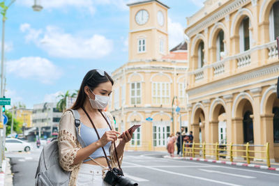 Traveler woman walking at old town phuket, thailand. travel alone, summer and holiday concept