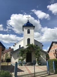 Low angle view of bell tower against sky