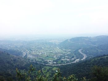 Scenic view of landscape against sky during foggy weather