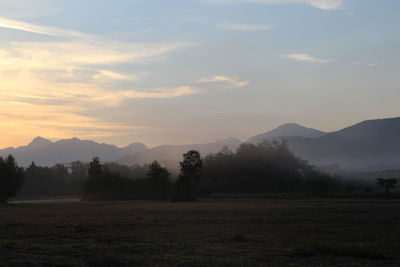 Scenic view of field against sky during sunset