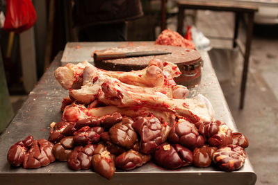 Kidneys and bones on a butcher's bench in xian wet market.