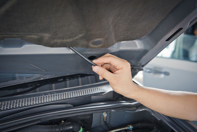 Auto mechanic checking car engine,worker selective focus