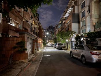 Cars on road amidst buildings in city