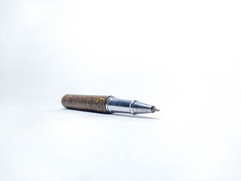 Close-up of pencil on table against white background