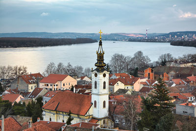 High angle view of townscape by sea against sky