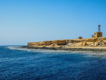 Scenic view of sea against clear blue sky