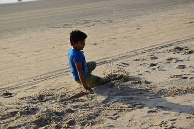 Side view of boy on beach