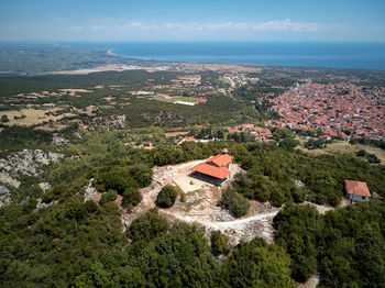 High angle view of buildings by sea against sky