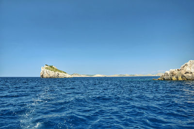 Scenic view of sea against clear blue sky