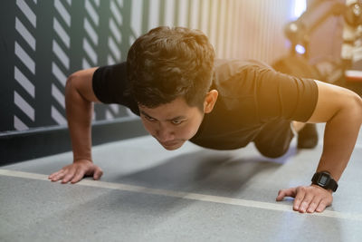 Rear view of shirtless boy looking at camera