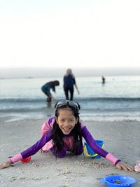 Portrait of young woman wearing swimming suit at the beach
