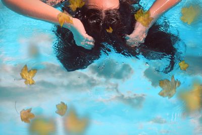 Reflection of woman swimming in sea