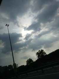 Low angle view of silhouette street light against sky