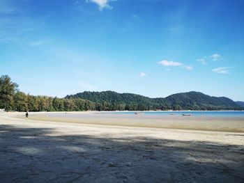 Scenic view of beach against blue sky