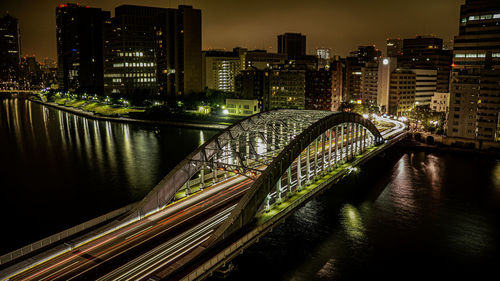 A long exposure shot of a bridge over a river in tokyo city japan