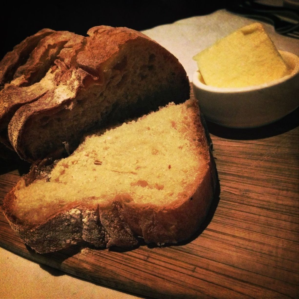 food and drink, food, still life, indoors, freshness, table, high angle view, wood - material, healthy eating, close-up, bread, cutting board, ready-to-eat, no people, slice, wooden, brown, indulgence, baked