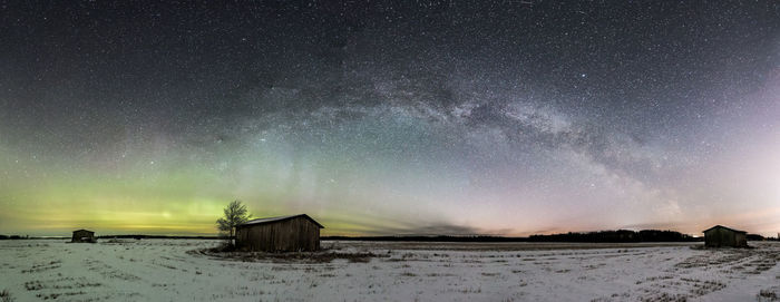 Scenic view of snow field against sky at night