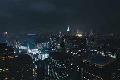 High angle view of illuminated buildings against sky at night