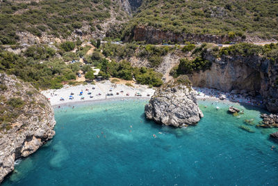 High angle view of rocks on sea shore