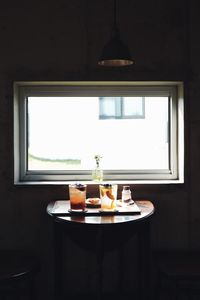 Table and lamp in glass window