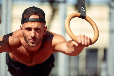 Portrait of young man exercising in gym